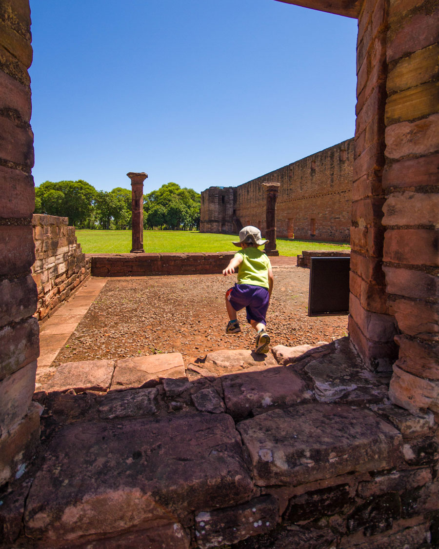 A young boy jumps from the ledge of a window at Jesuit missions in Paraguay
