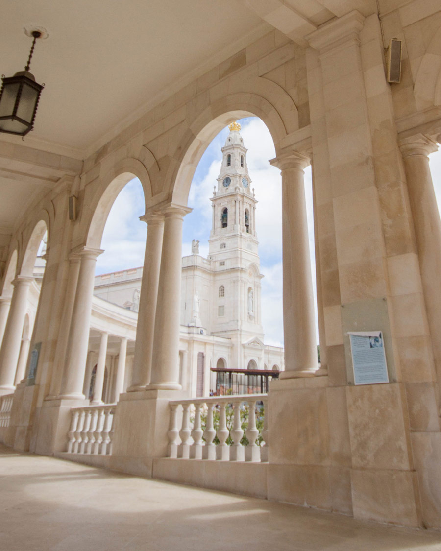 The Shrine of Fatima framed by the arches of the covered walkways