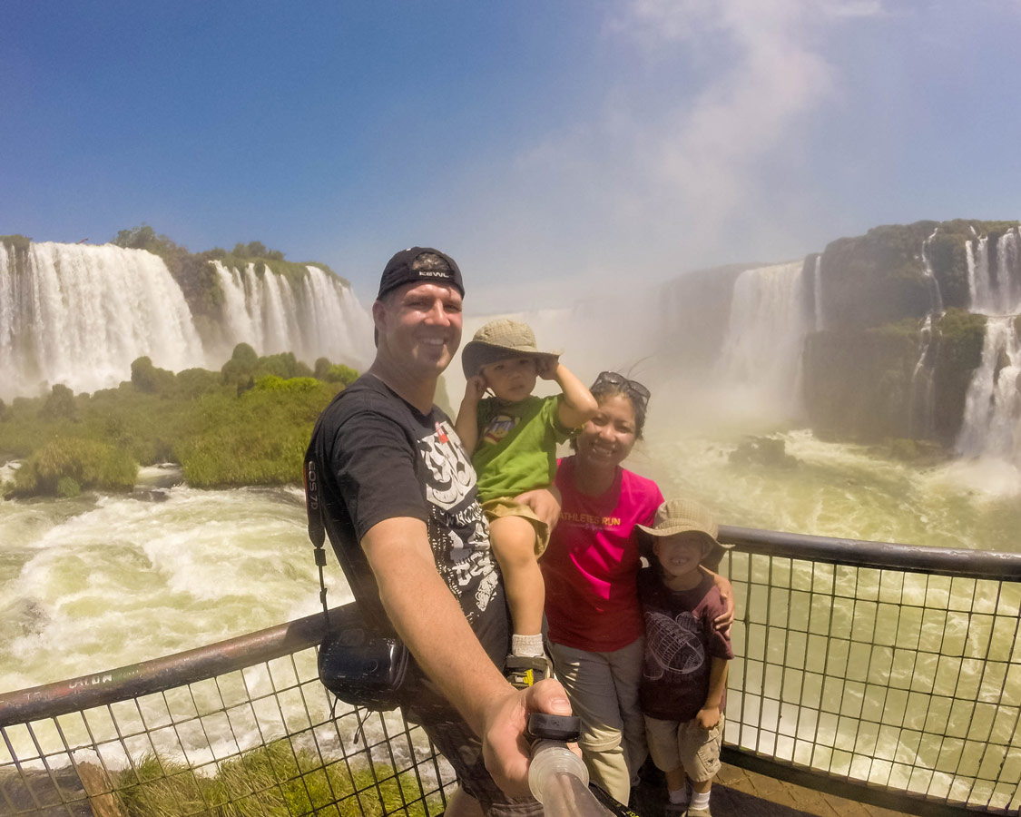 Family take a selfie at the end of the Cataratas Trail in Iguazu Falls Brazil.