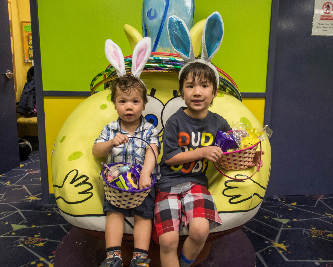Two boys with their Easter baskets full of candy.