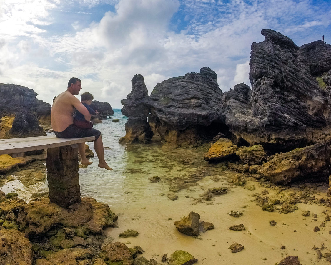 Man with boy enjoying the view from Tobacco Bay in St George Bermuda.