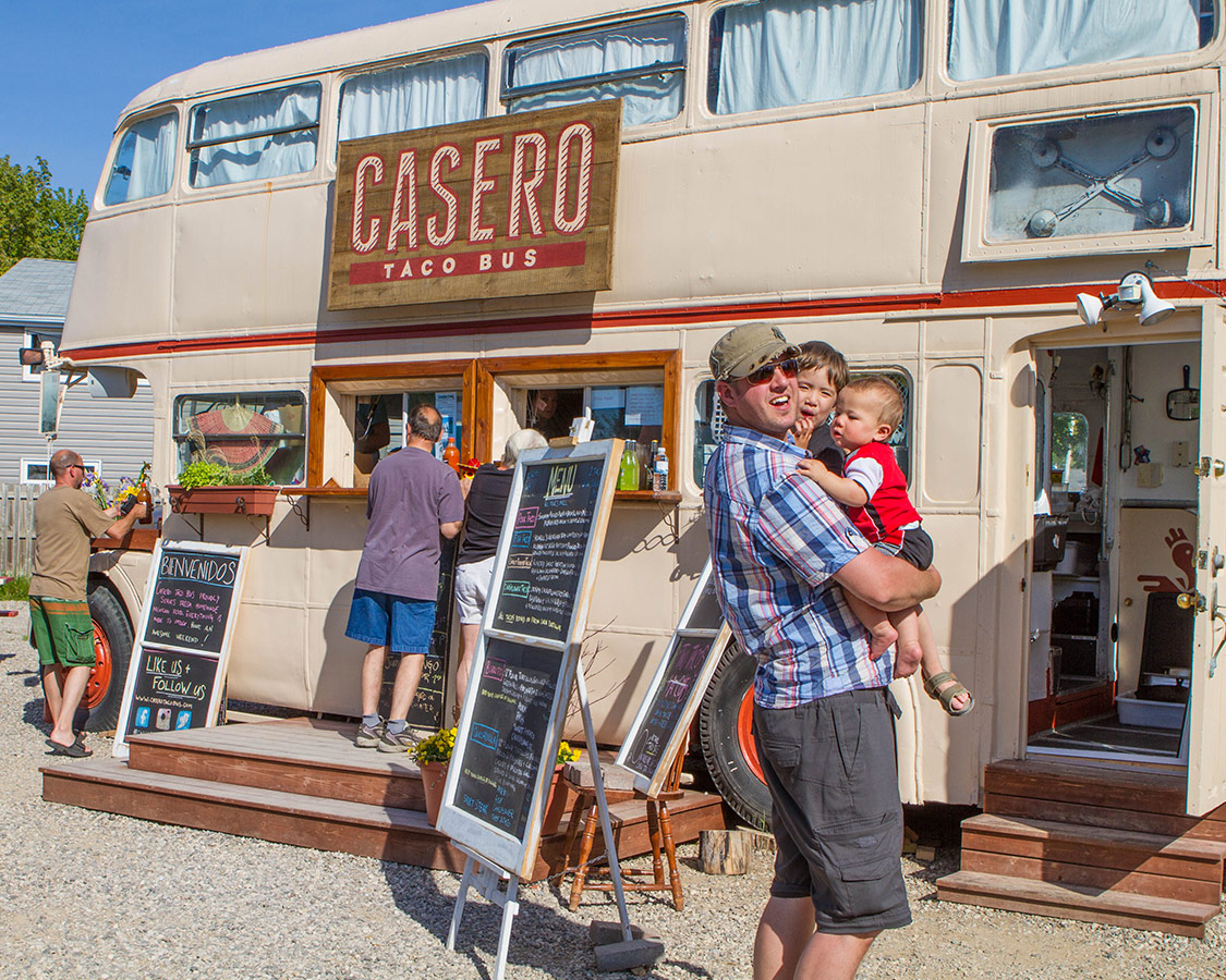Man and boys waiting at Casero Taco Bar in Sauble Beach town.