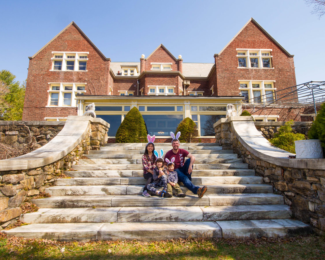 Families sits on the grand staircase going out into the backyard of the Wilburton Inn.