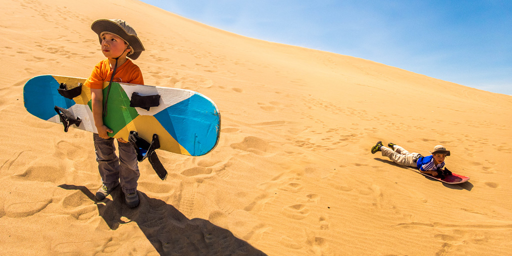 Huacachina is a town made famous by those in search of adrenaline. Check out why we think that riding dune buggies and sandboarding Peru with kids is epic!