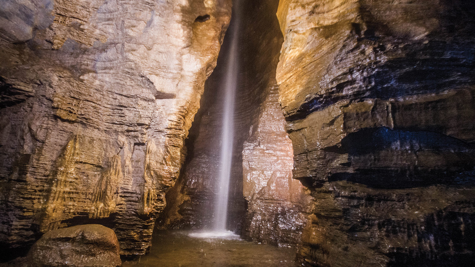 The 100-ft waterfall at the end of the guided tour of Secret Caverns New York was the highlight of our family trip to this show cave.