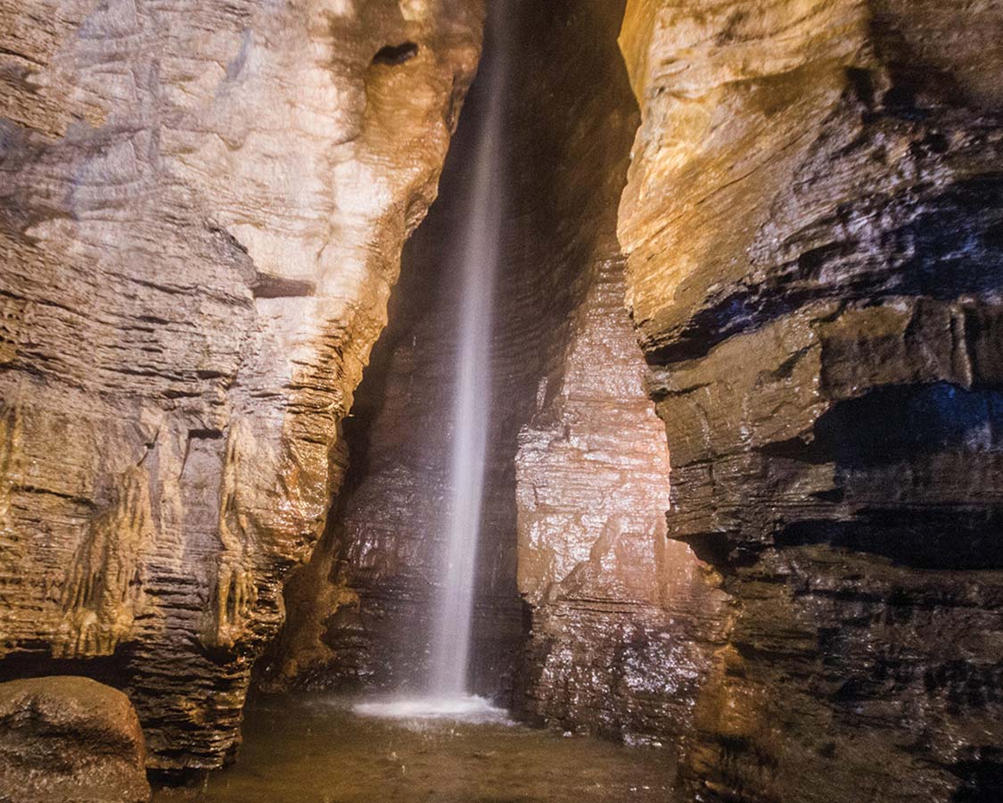 The 100-ft waterfall at the end of the guided tour at Secret Caverns New York is the highlight of the visit to this show cave.