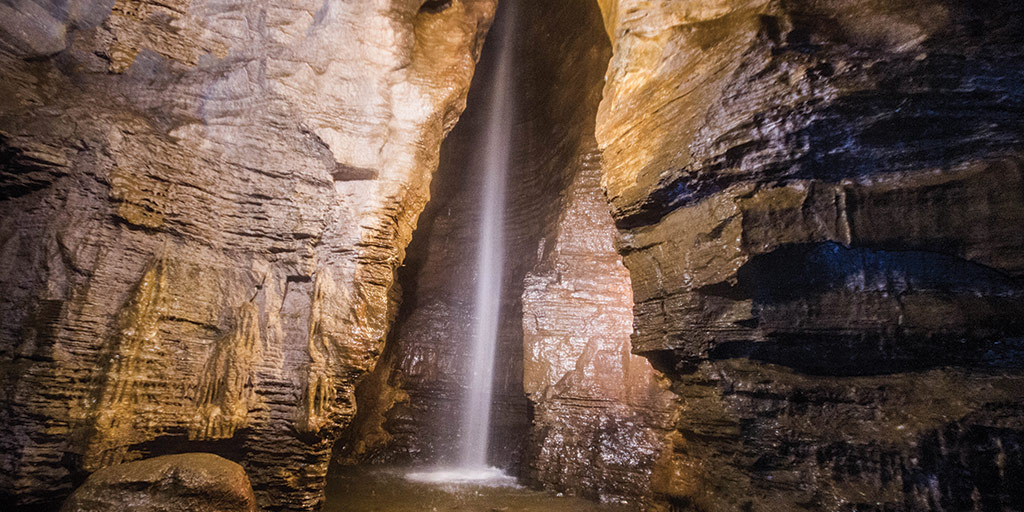 The 100-ft waterfall at the end of the guided tour at Secret Caverns New York is the highlight of the visit to this show cave.