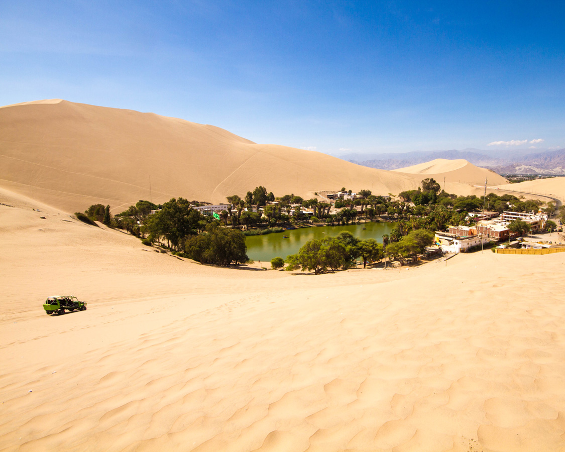 A dune buggy approaches the Huacachina oasis near Ica, Peru