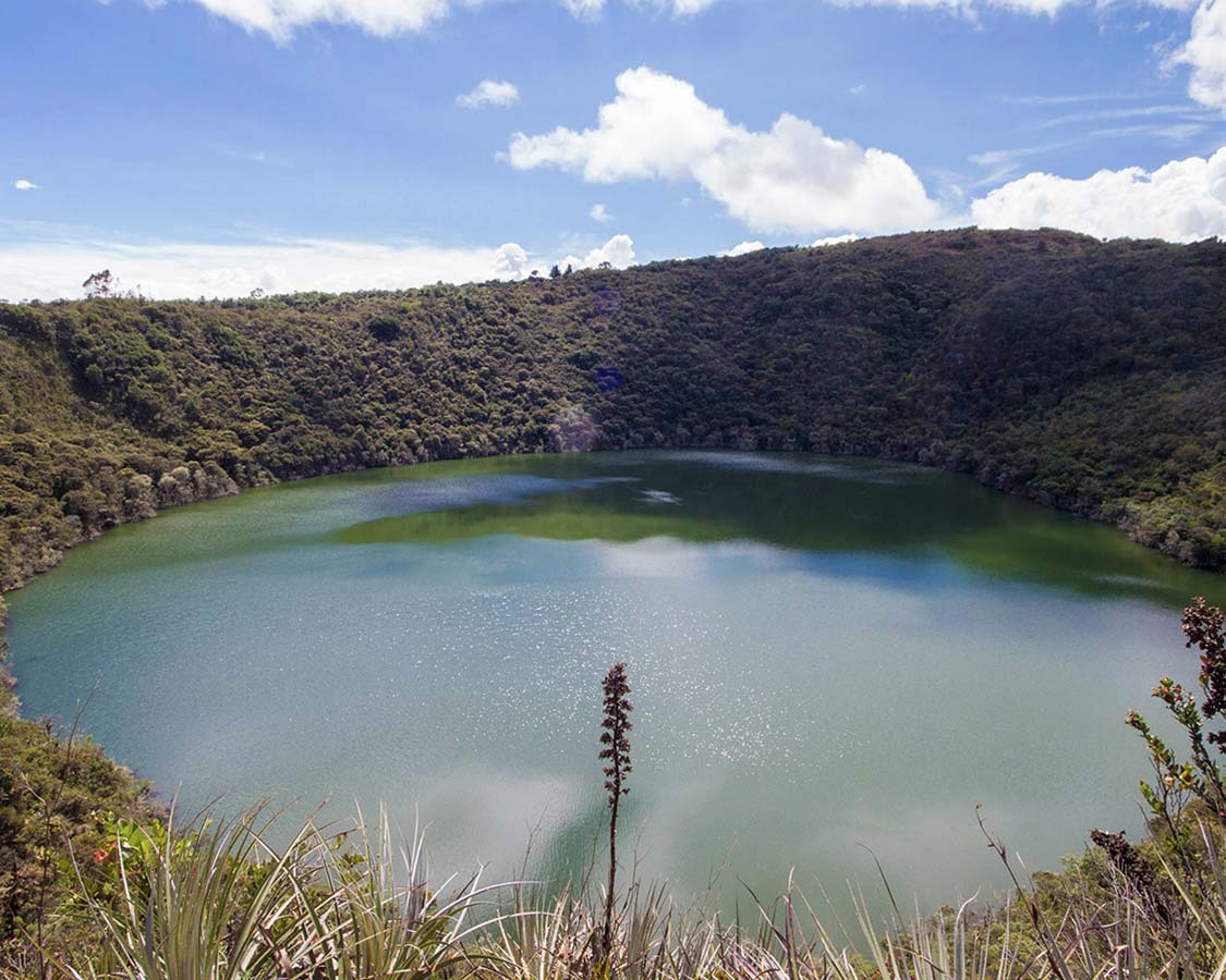 A crystal clear crater lake surround by thick jungle - Legend of El Dorado in Colombia