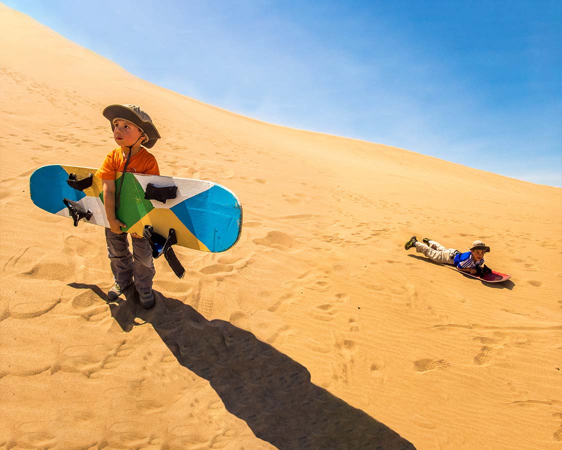 Huacachina is a town made famous by those in search of adrenaline. Check out why we think that riding dune buggies and sandboarding Peru with kids is epic!