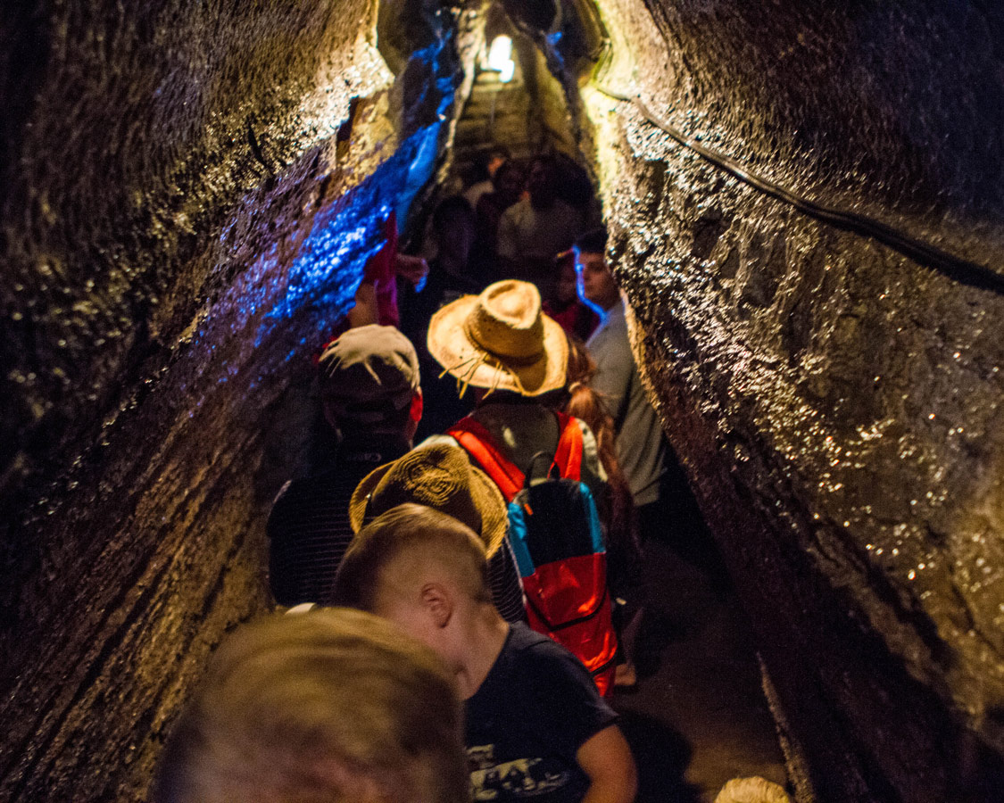 Crowds line the narrow tunnels of Bonnechere Caves with kids in Eganville Ontario