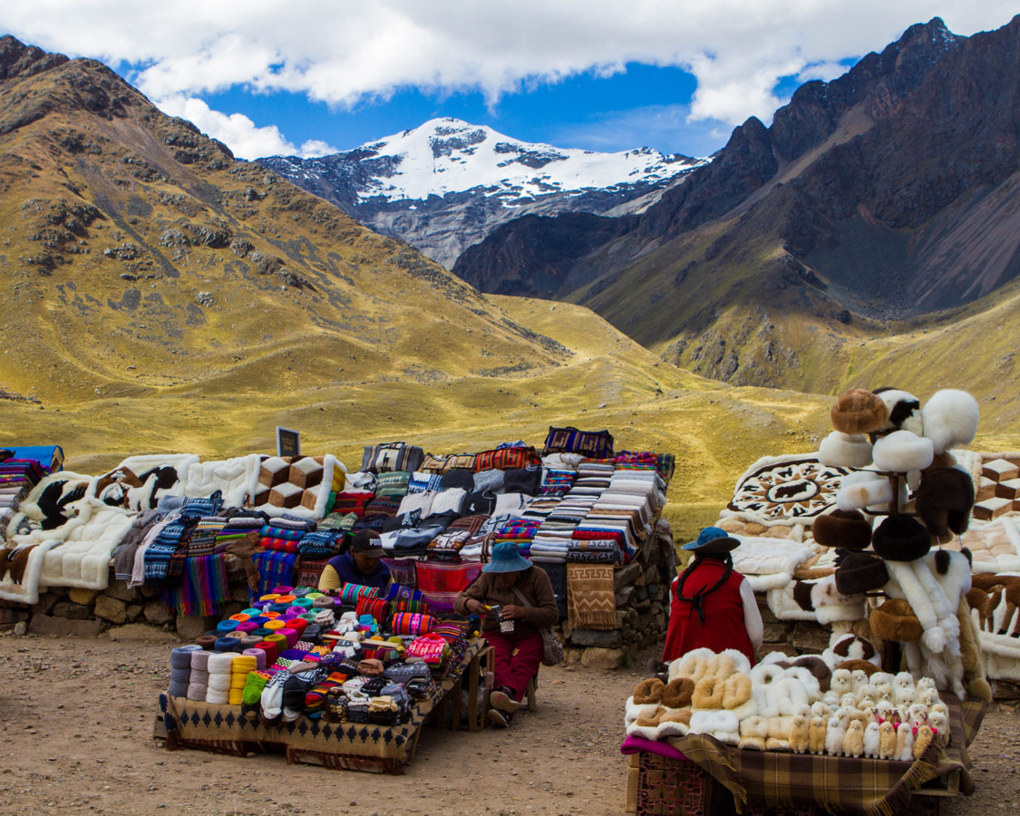 Local Quechua women sell handicrafts at a market in Abra la Raya Peru along the Cusco to Puno bus tour in Peru