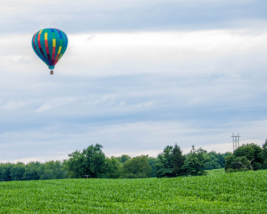 A hot air balloon rises over a field in Letchworth State Park in New York State