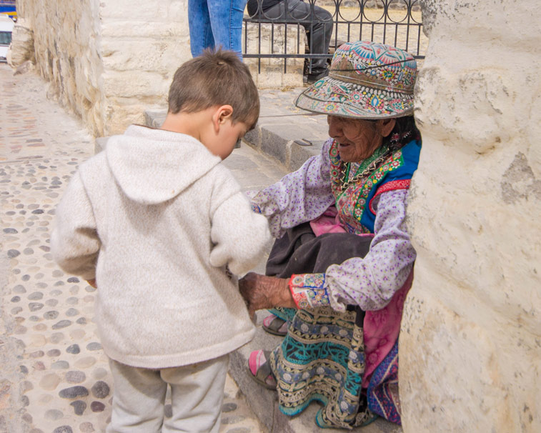 D meets a local Collagua woman on his way to see the Andean Condors in Colca Canyon with kids
