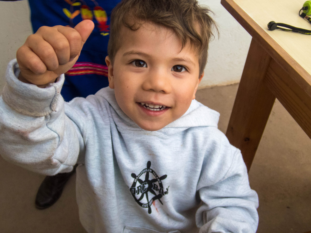A young bou smiles for the camera after the Taller Ceramica workshop by Pablo Semniario where we experienced ceramics painting for kids