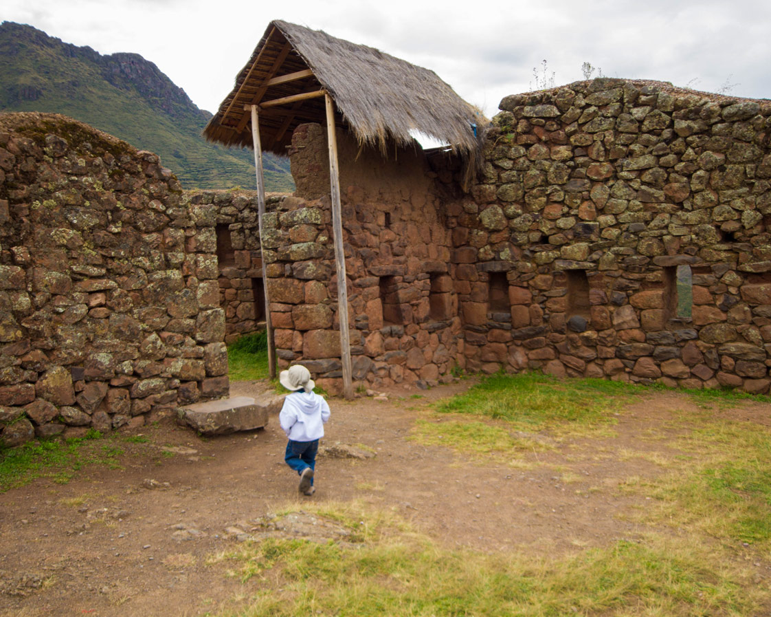 A child walks through the Inca ruins at the Pisac Archaeological Site near Pisac Peru