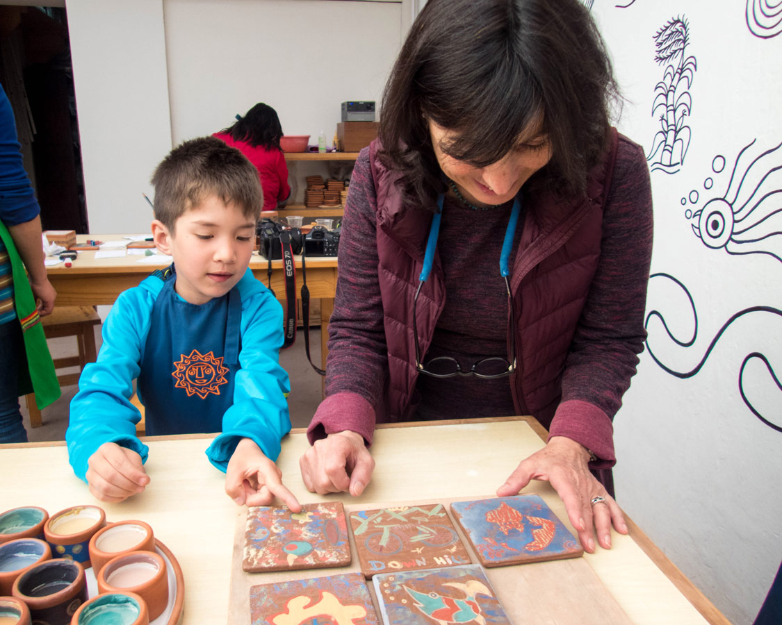 Marilu Behar shows C the finished product- of our Ceramic painting for kids workshop at the Pablo Seminario Taller Ceramica in Urubamba Peru