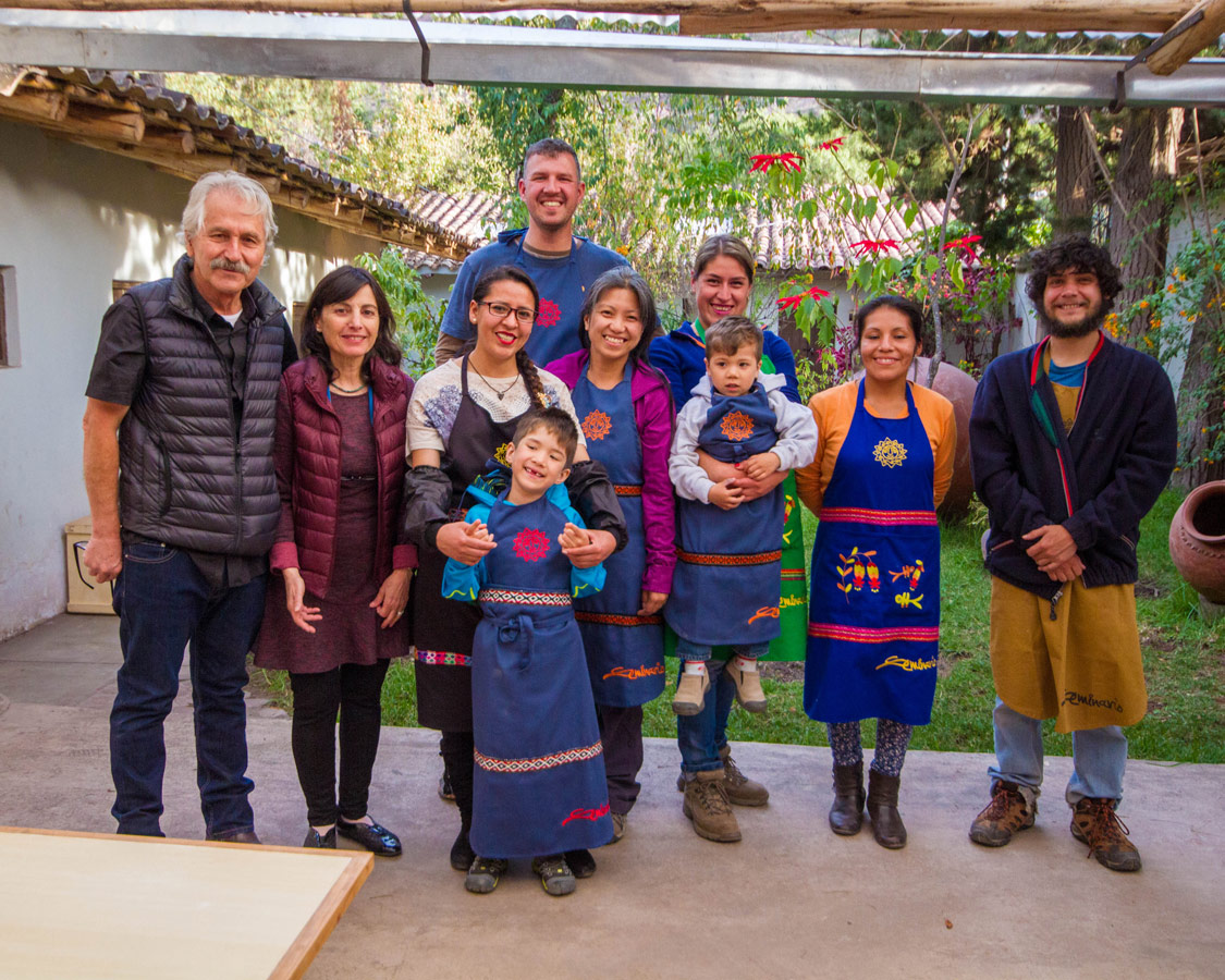 Pablo Seminario and Marilu Behar and their team at Taller Ceramica in Urubamba Peru pose with family travel writers Kevin Wagar and Christina Wagar and their children