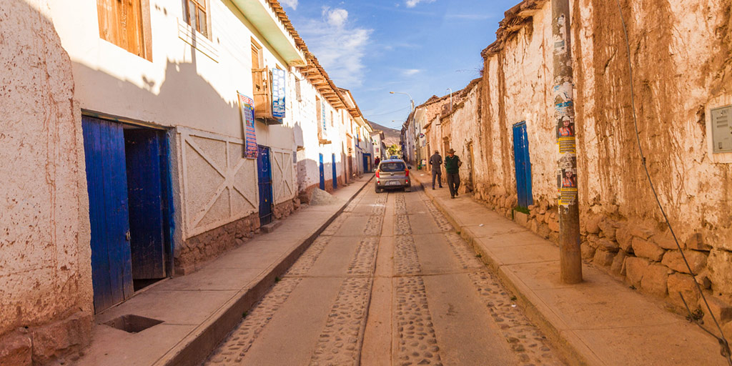 blue doors and adobe buildings in a beautiful street seen in Moray Peru on a daytrip to the Sacred Valley Peru