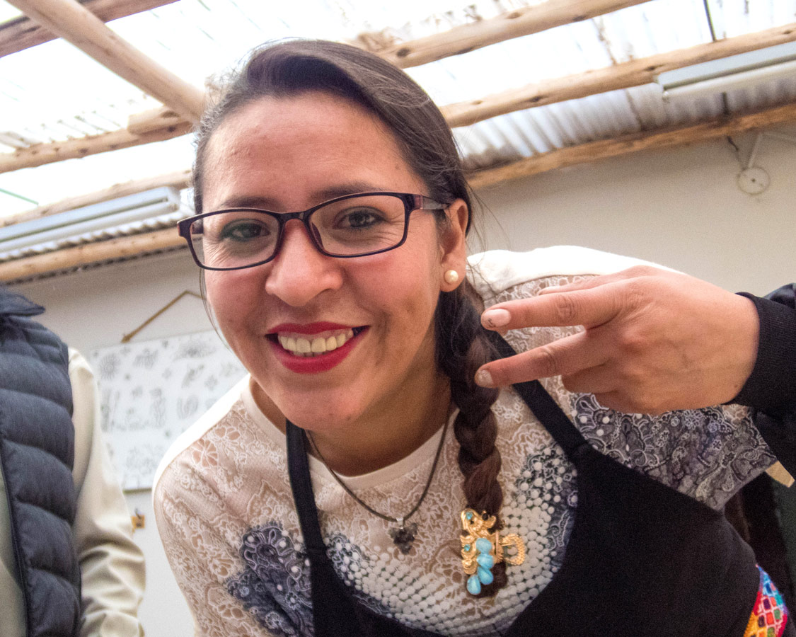 A staff member of Taller Ceramica and Pablo Seminario at a ceramics painting for kids workshop in Urubamba Peru