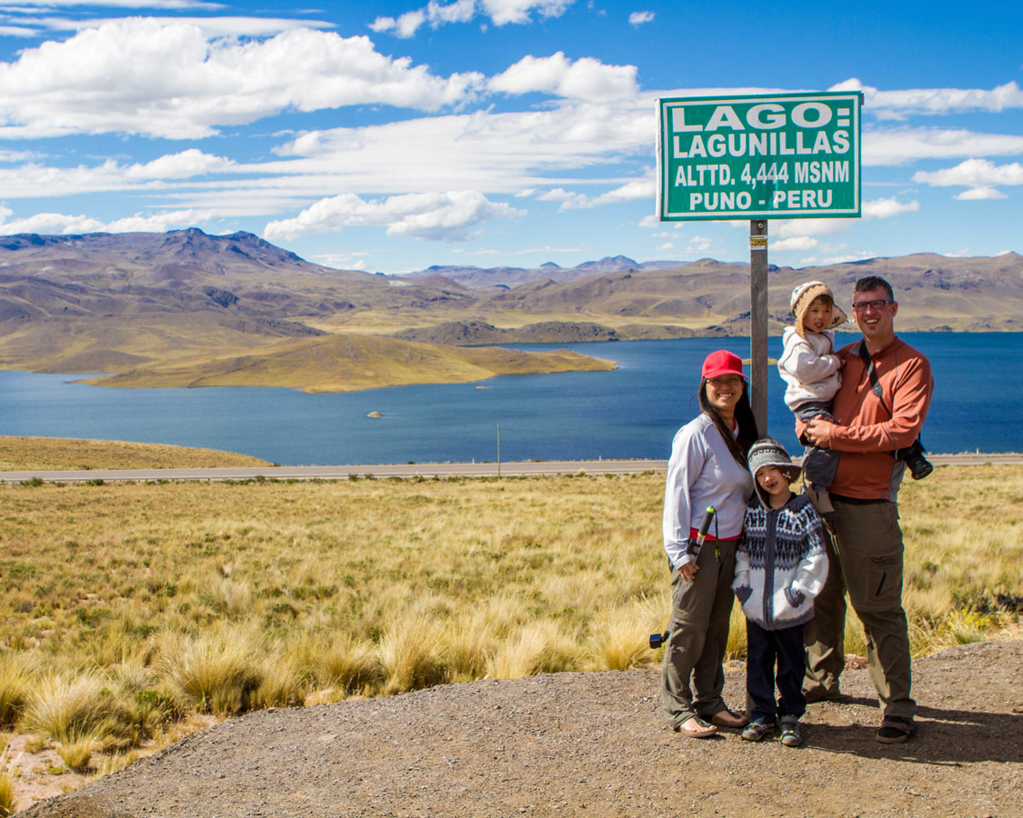 The Wandering Wagars pose for a family photo at Lago in the Peruvian Andes on the way to see the Andean Condors in Colca Canyon with kids