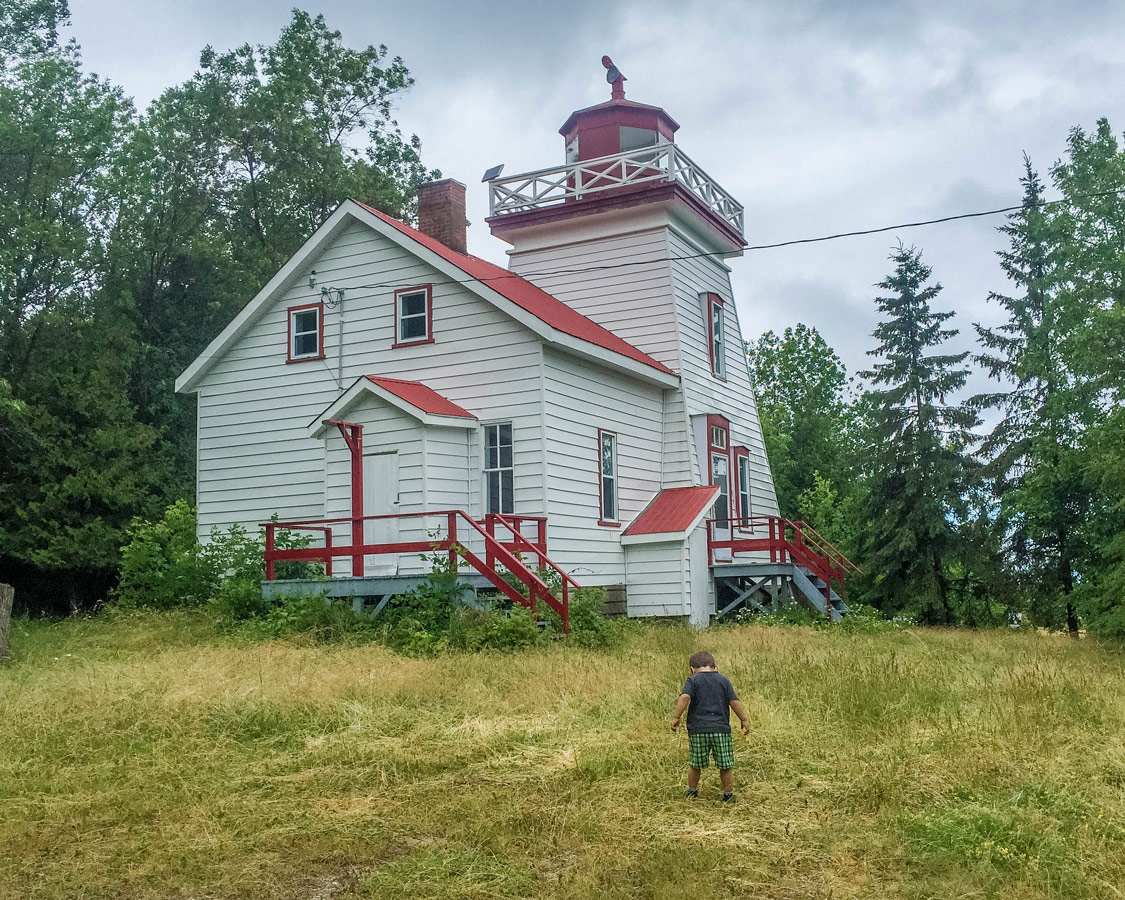 A young boy explores the grounds of the Janet Head Lighouse on Manitoulin Island. It's one of the best things to do on Manitoulin Island