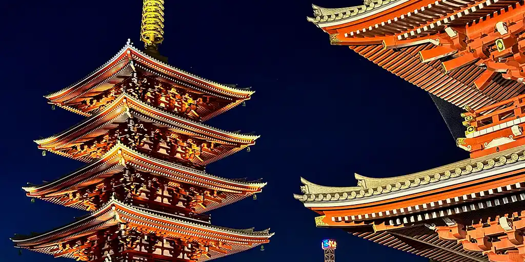 Temples in Japan lit up against the night sky