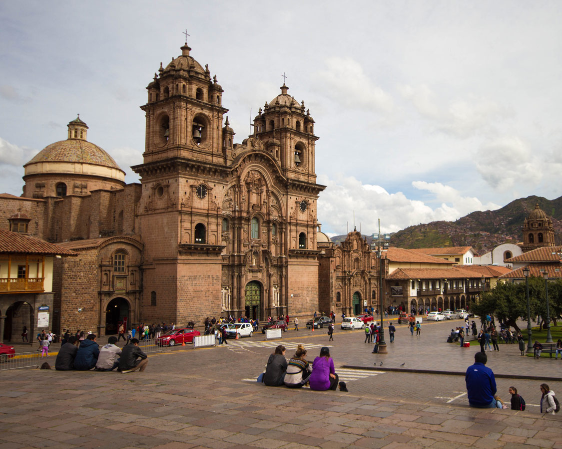 Visiting the Plaza d'Armas is one of the best things to do in Cusco. Locals and tourists alike relax on the stone steps in front of the churches and eat local treats.
