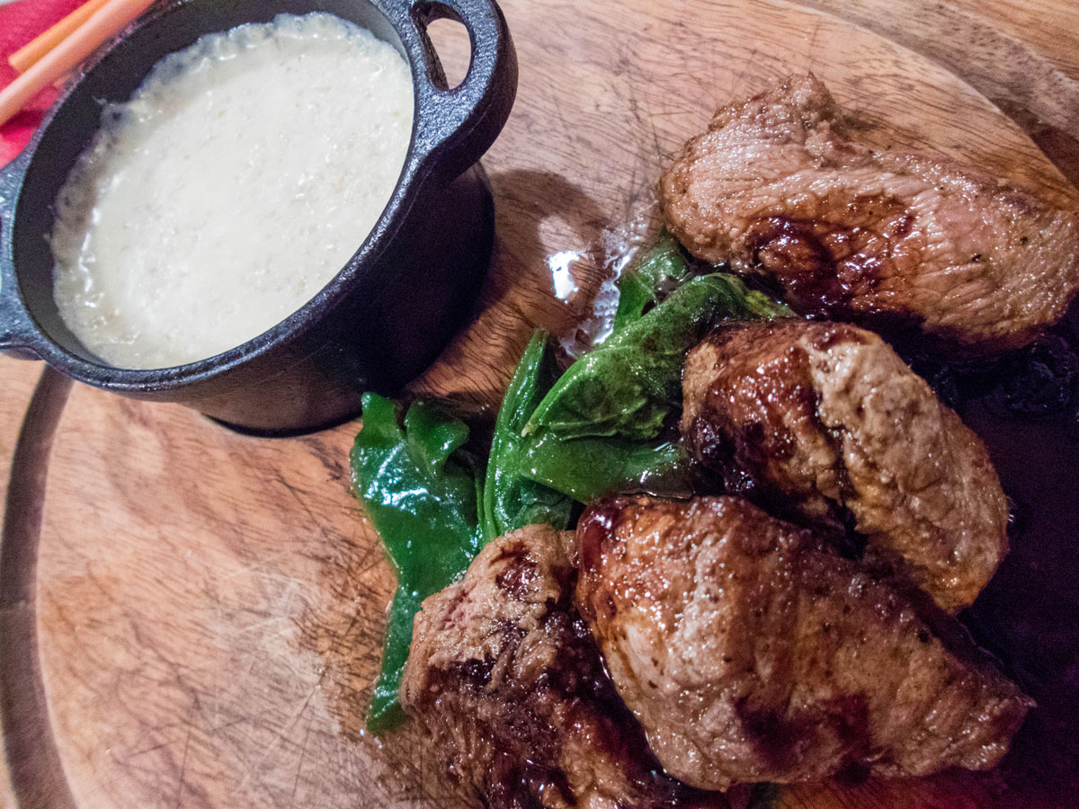 Alpaca steaks at Mojsa Bar in Puno Peru with kids on a 14 day Peru itinerary