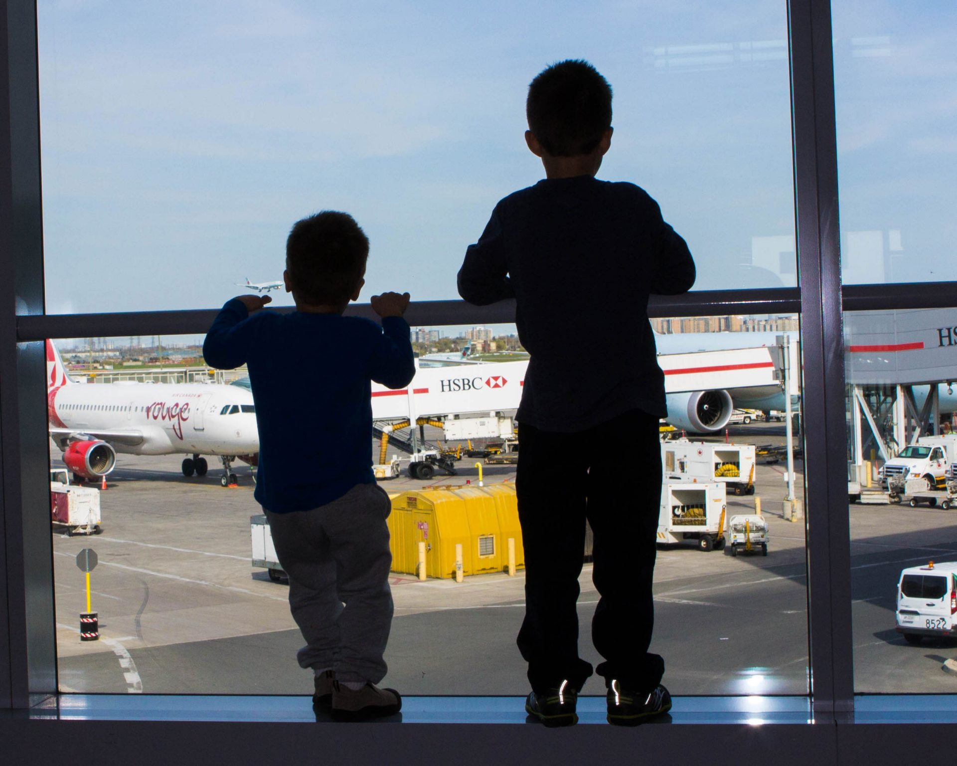 Boys waiting for a flight to Peru with kids at Toronto Pearson Airport for 2 weeks in Peru