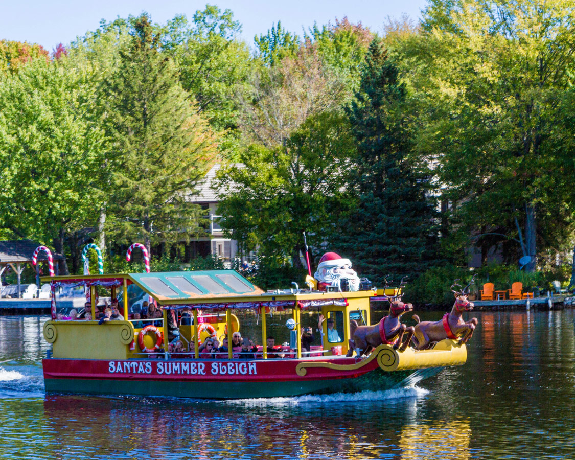 Santas boat from Santas Village in Bracebridge Ontario seen from a Lady Muskoka boat cruise on the Muskoka river