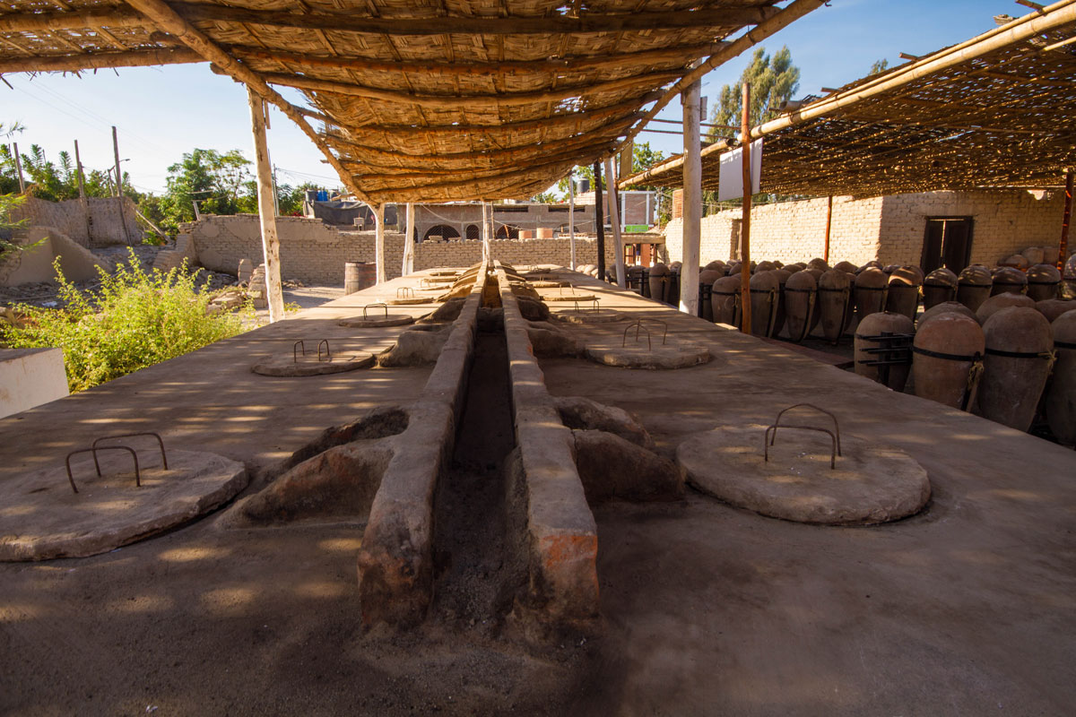Wine distilling barrels for making Pisco Sours in Pisco Peru with kids