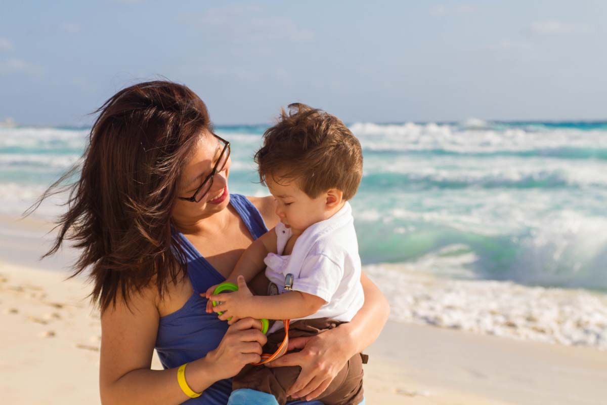 Christina Wagar and C on the beach in Tulum Mexico with kids