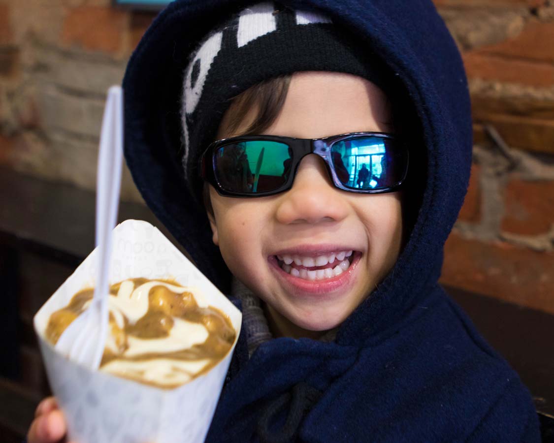 Eating Moo Frites Poutine on a Toronto Food Tour in Kensington Market with Tasty Tours Toronto