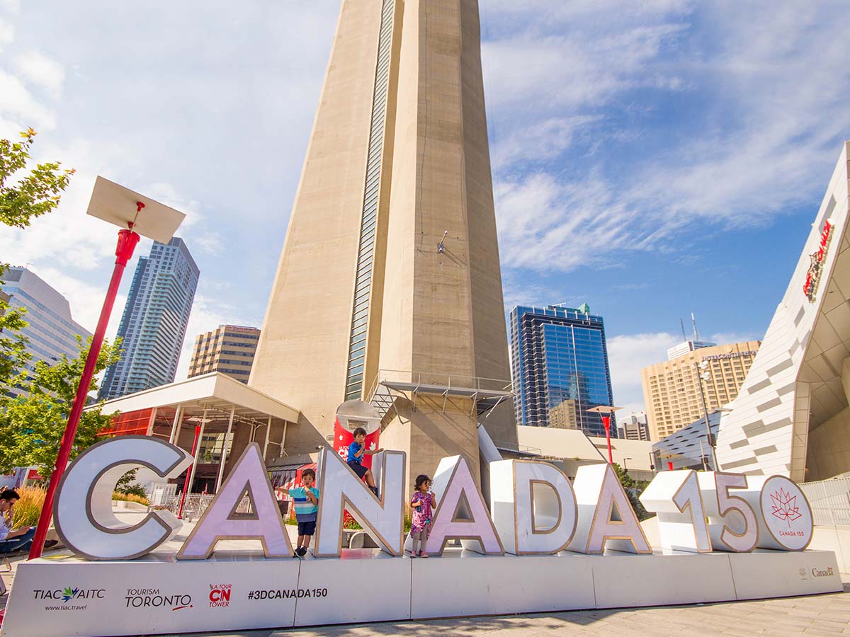 Canada 150 sign in front of the CN tower in Toronto Ontario