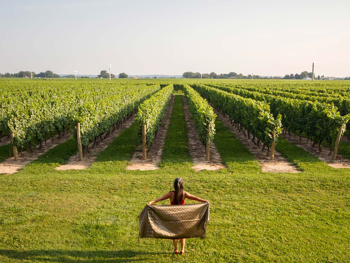 Christina Wagar poses in front of the vineyards in Niagara on the Lake Ontario