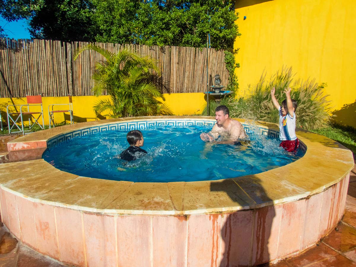 Man with 2 boys in a small circular pool in Brizas del Norte hotel in San Ignacio Argentina