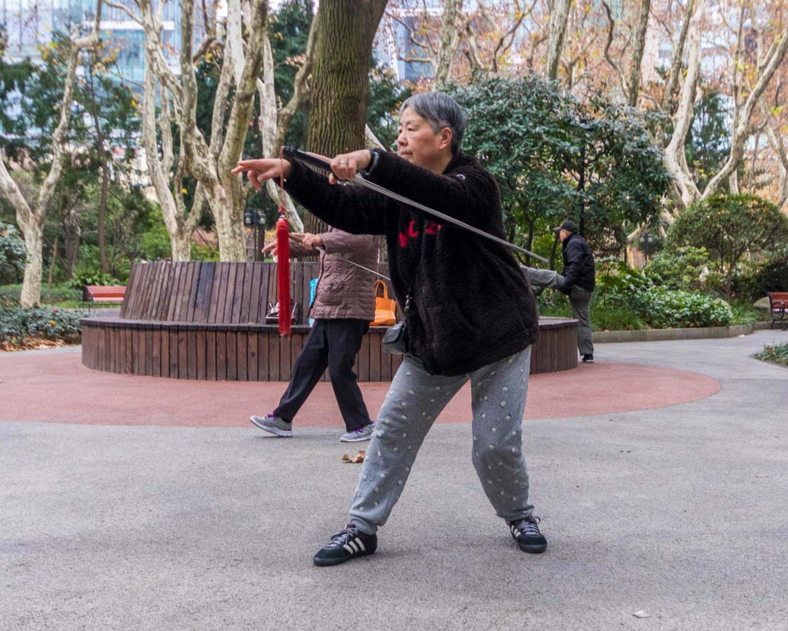 Women with swords perform excercises at Xiangyang Park in Shanghai China