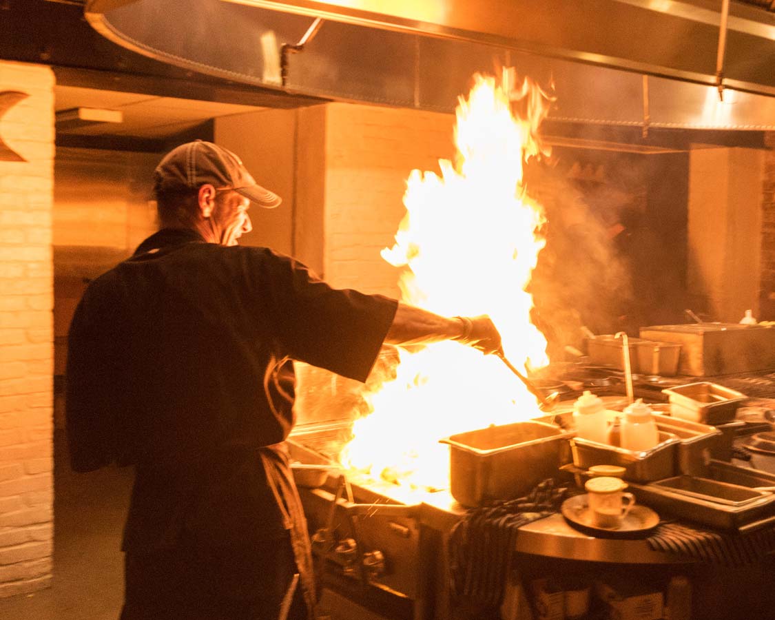 Chef at Ulele restaurant in Tampa Bay Florida grills oysters