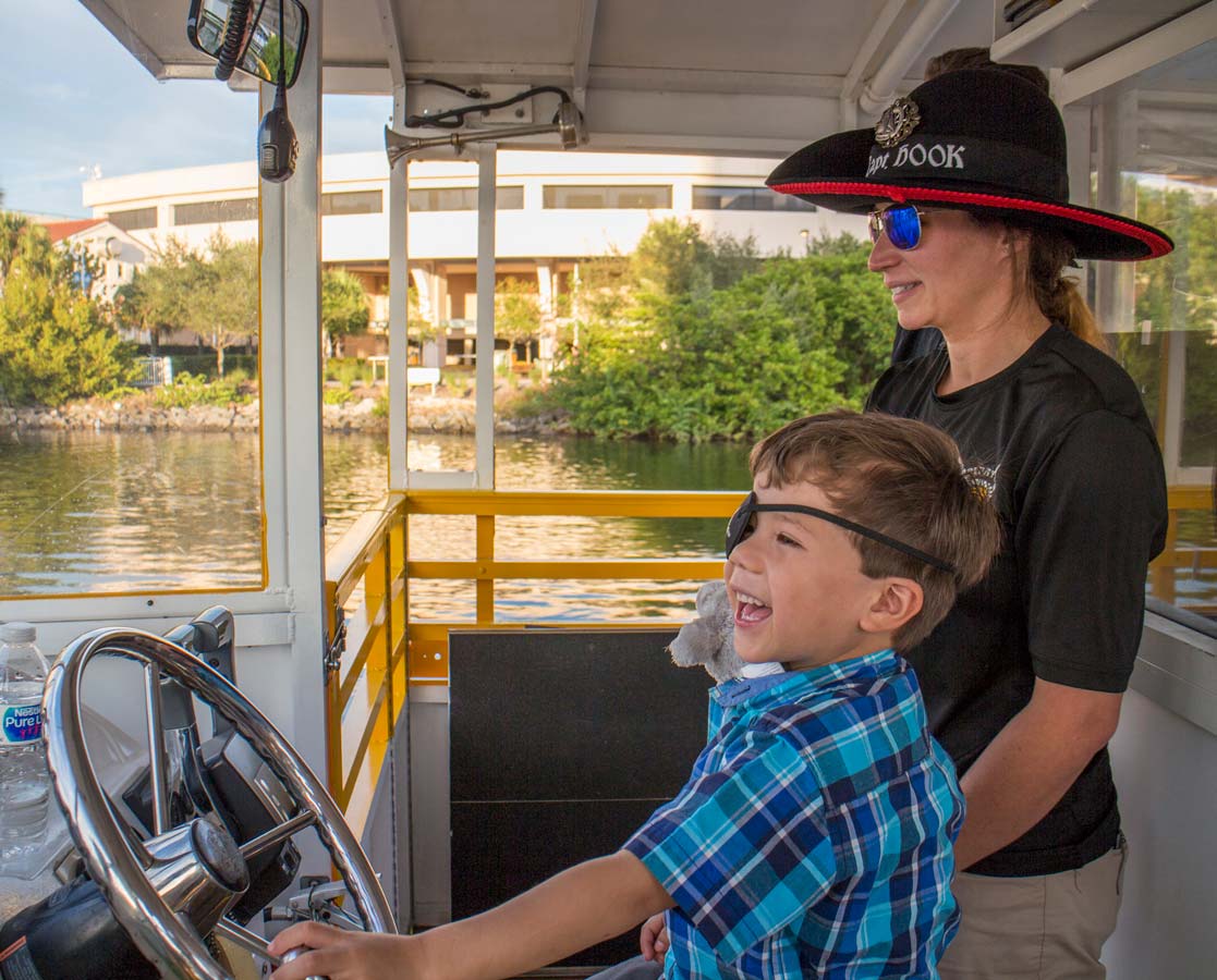 A young boy laughs on the Tampa Pirate Water Taxi along the Tampa Riverwalk in Florida