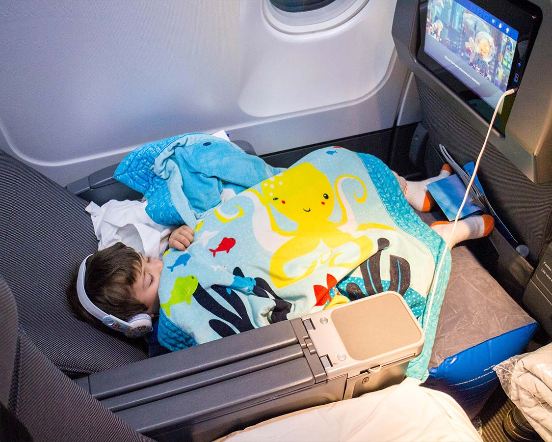 The 1st Class Kid Travel Pillow is an inflatable footrest for airplanes that fits in the space between seats in order to create a seamless reclining area for children to fly legs up. There are things that users need to know about flying with an airplane leg rest and we lay out everything we learned from our experience.