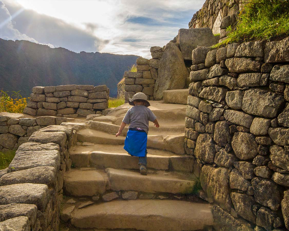 Boy climbing Machu Picchu