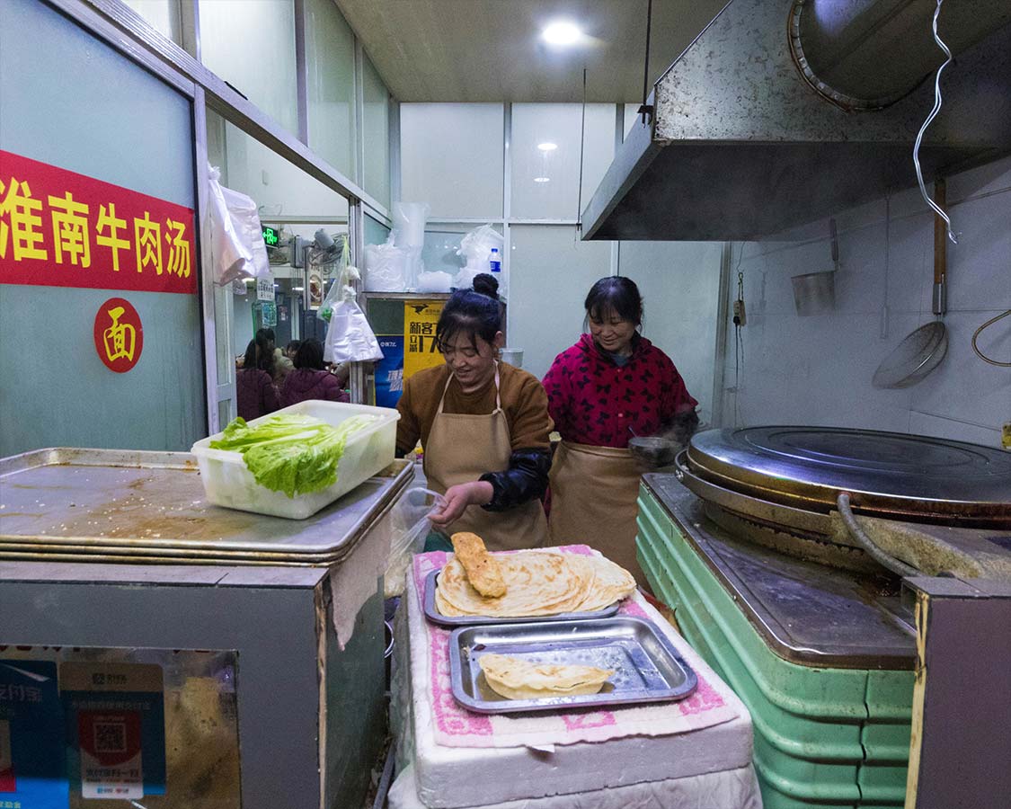Cooks prepare Chinese soup at a restaurant in Shanghai China