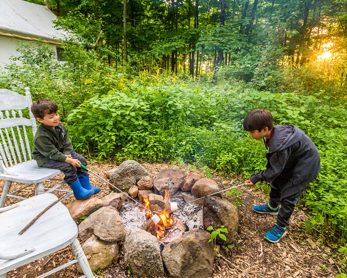 Kids Roasting Marshmallows at Fronterra Glamping in Prince Edward County