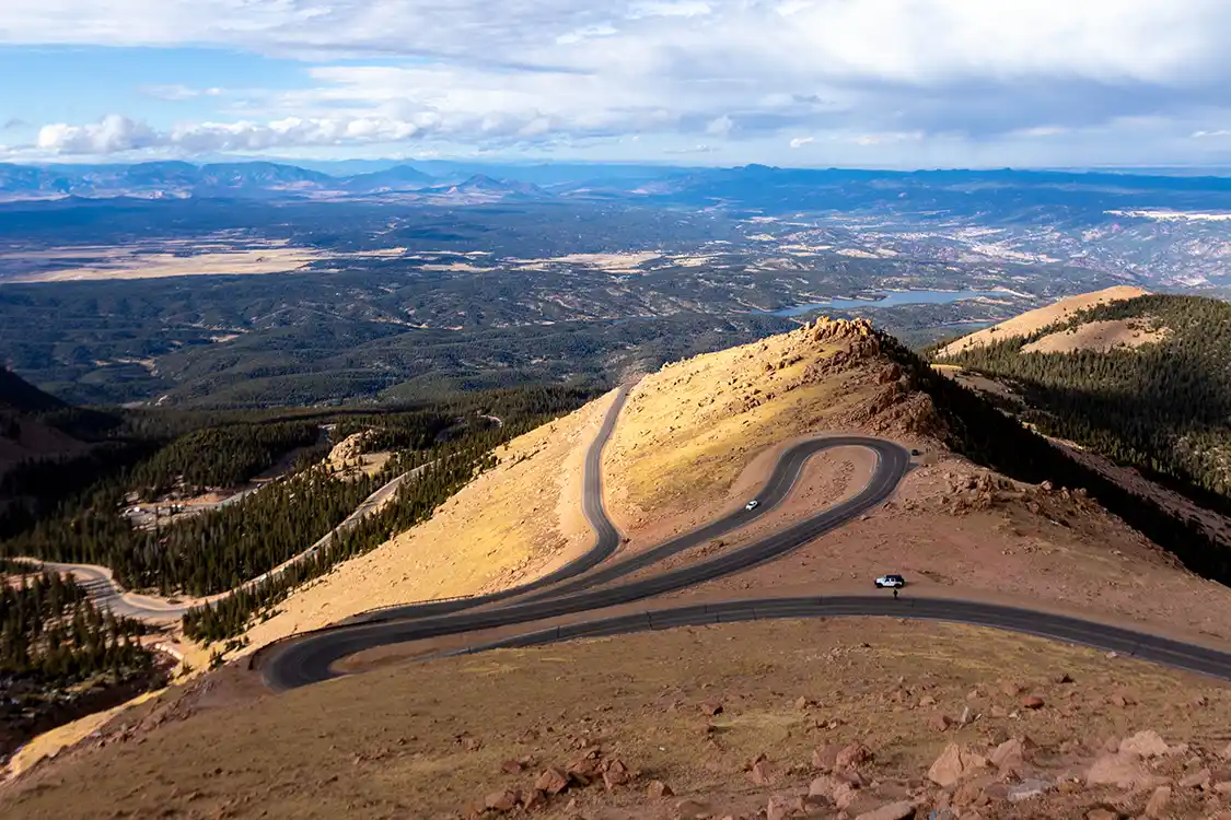 The sunlight shines over the switchbacks on the Pikes Peak drive