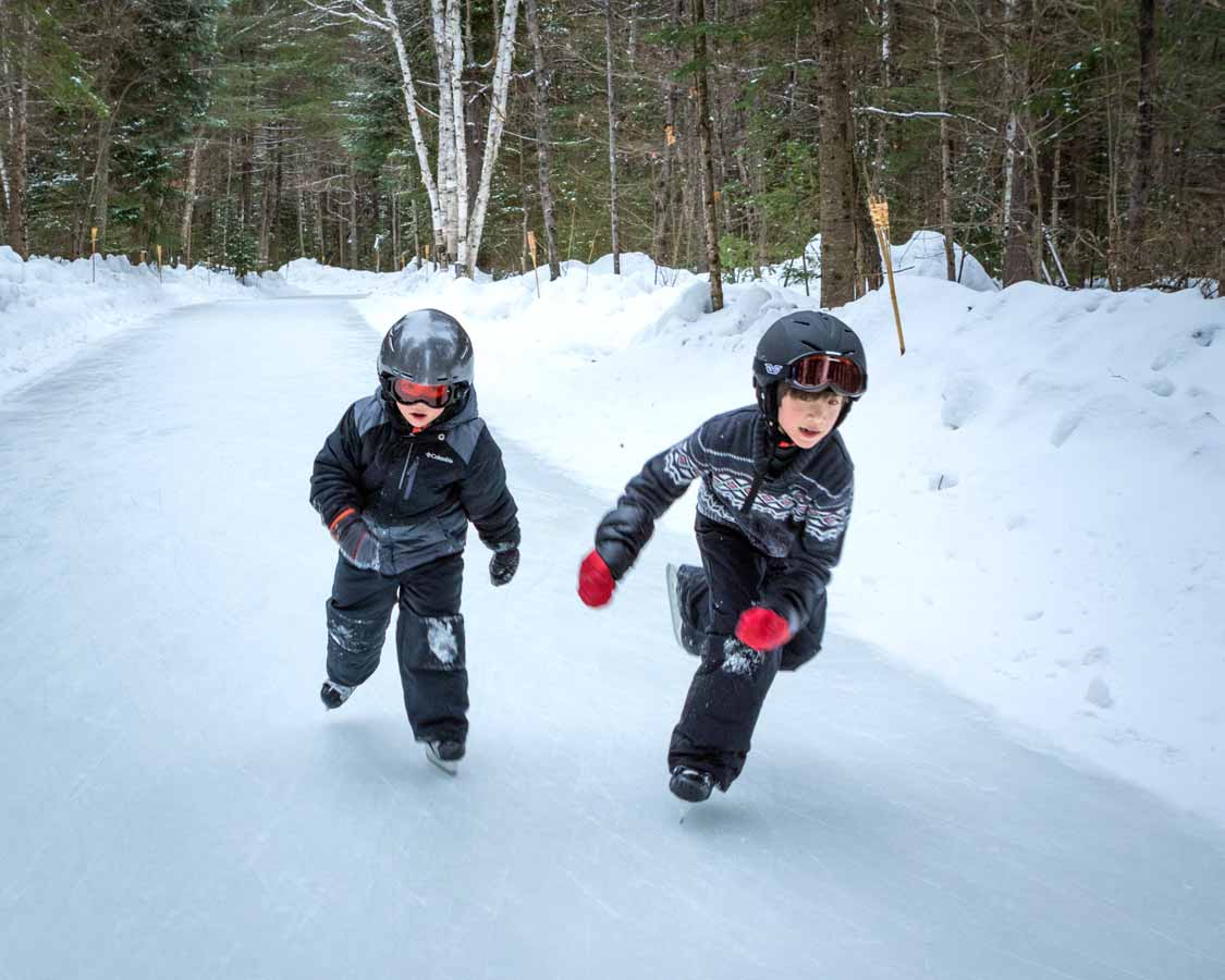 Two boys skating during winter at MacGregor Point Provincial Park