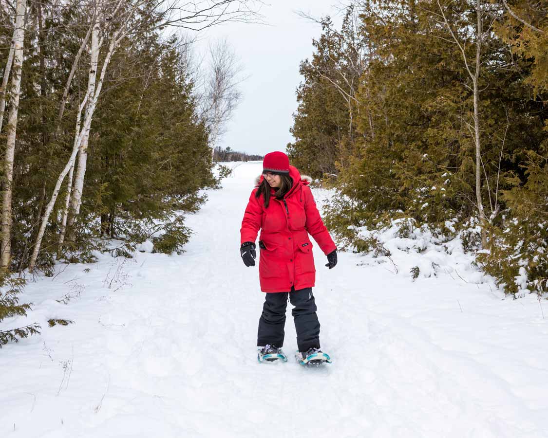 Woman snowshoeing in Macgregor Point in winter