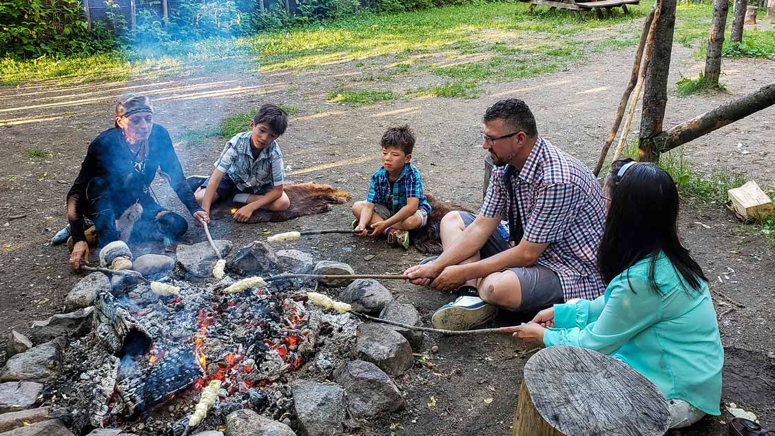 Cooking Indigenous bannock-over a fire in Wendake Quebec