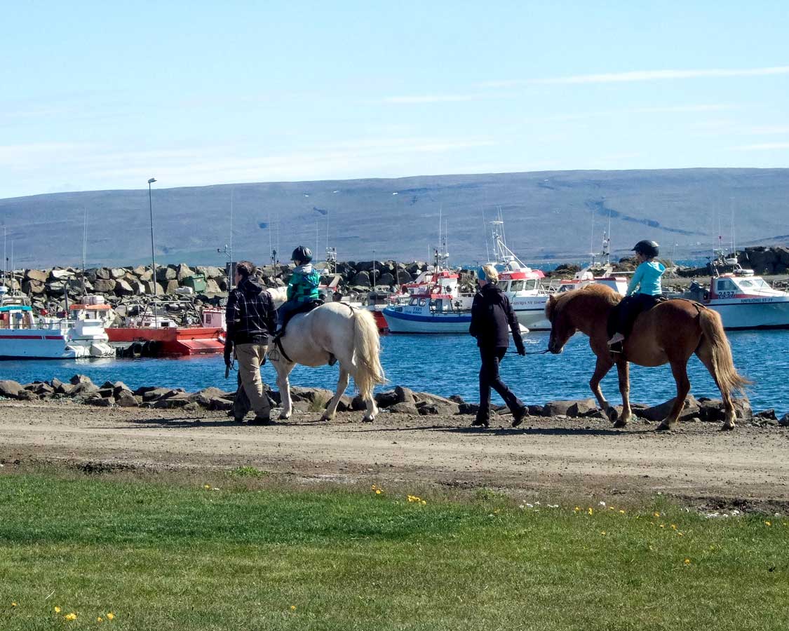 Children ride horses during a summer festival in Iceland