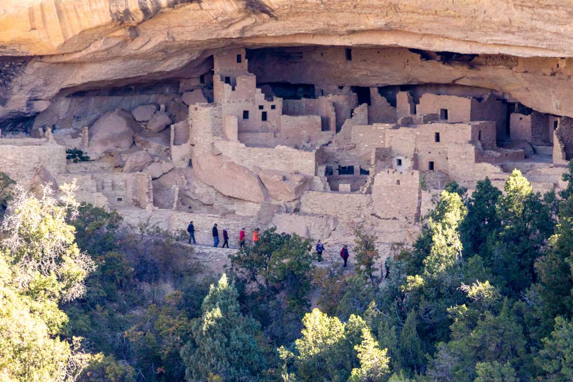 Visitors tour Puebloan ruins in Mesa Verde National Park